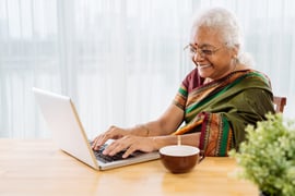Happy-senior-woman-working-on-laptop-1024x683