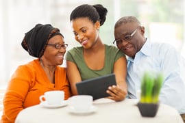 cheerful-african-family-at-home-using-tablet-pc-1024x683