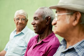 retired-elderly-people-and-free-time-group-of-happy-senior-african-american-and-caucasian-male-friends-talking-and-sitting-on-bench-in-park-1024x683
