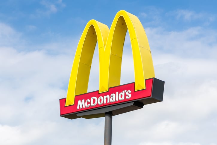 McDonald's Exterior Golden Arches Sign and Trademark Logo outdoors with blue sky in the background 