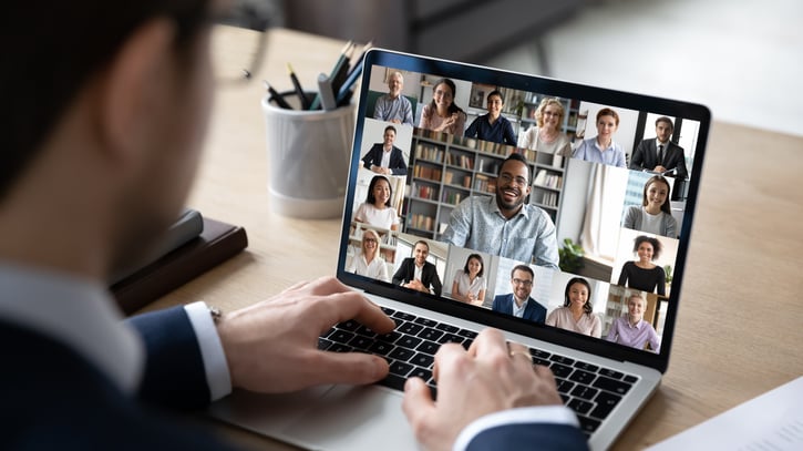 Businessman talking to team of colleagues on online video conference call on laptop. Screen view of coach, teacher and students attending webinar.
