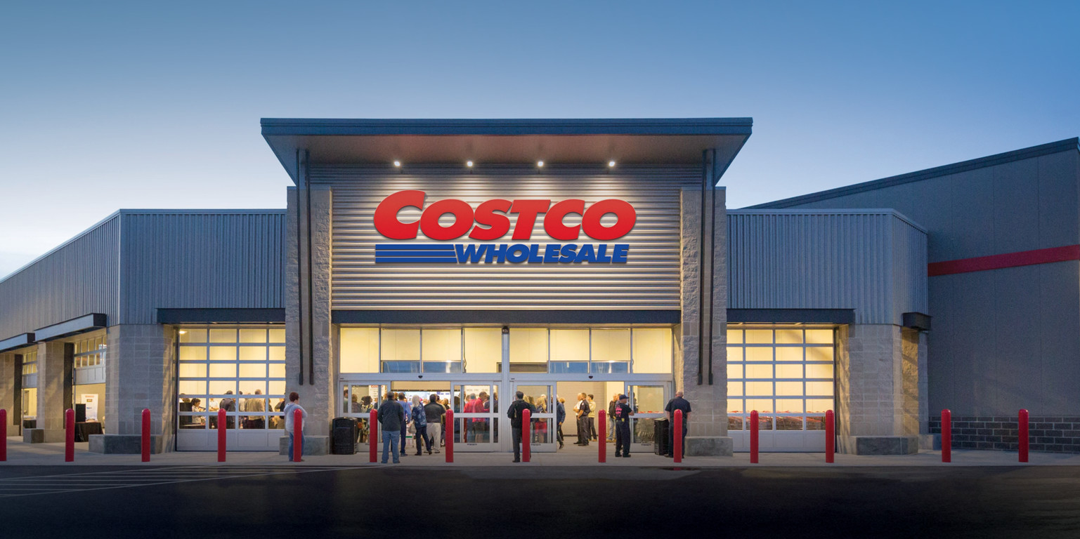 During the evening, several consumers queue both inside and outside the Costco Wholesale Store.