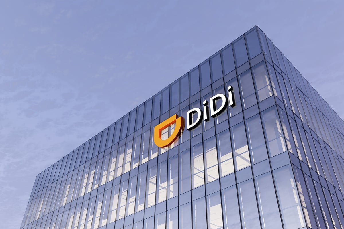On the corner of a blue building, the Didi Global Inc. logo is placed in white and yellow.