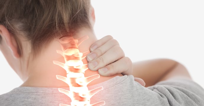 Woman holding her neck as a result of a repetitive strain injury