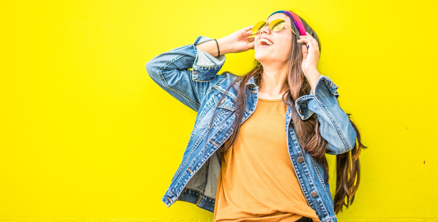 Smiling woman against yellow backdrop