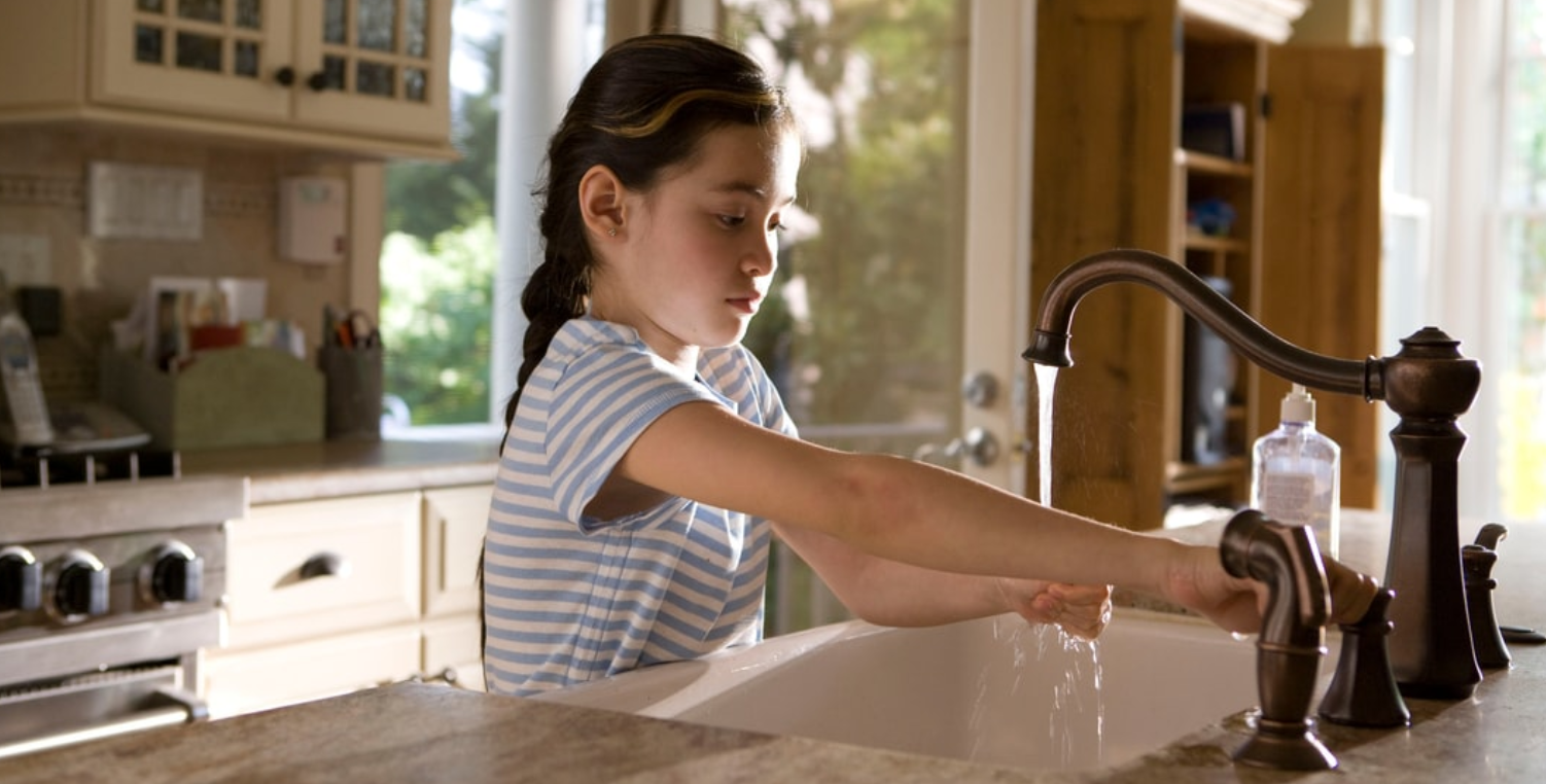 young girl washing hands