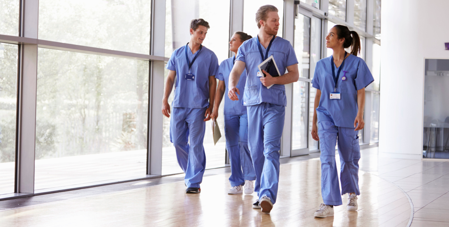medical workers walking through hospital