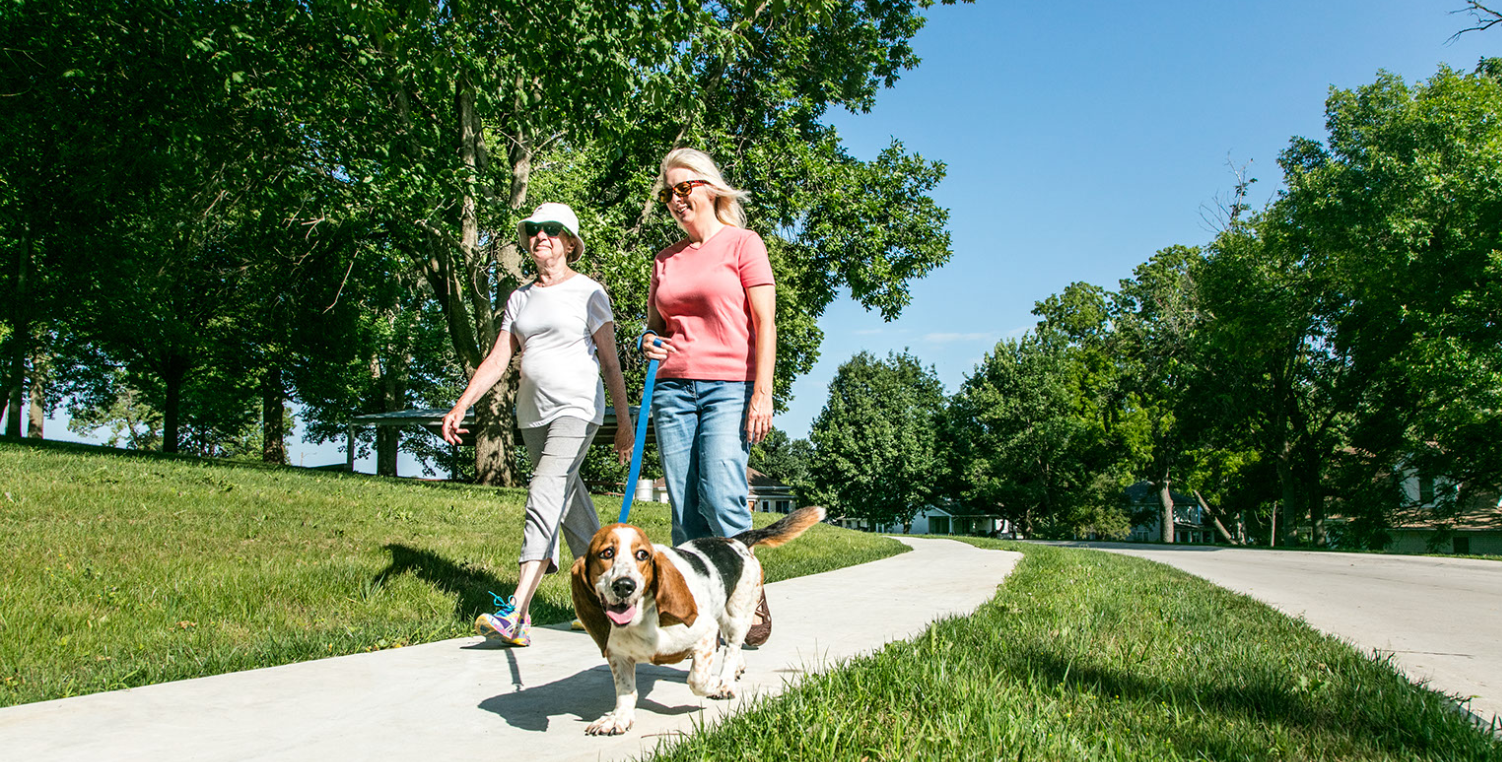 two women walking dog