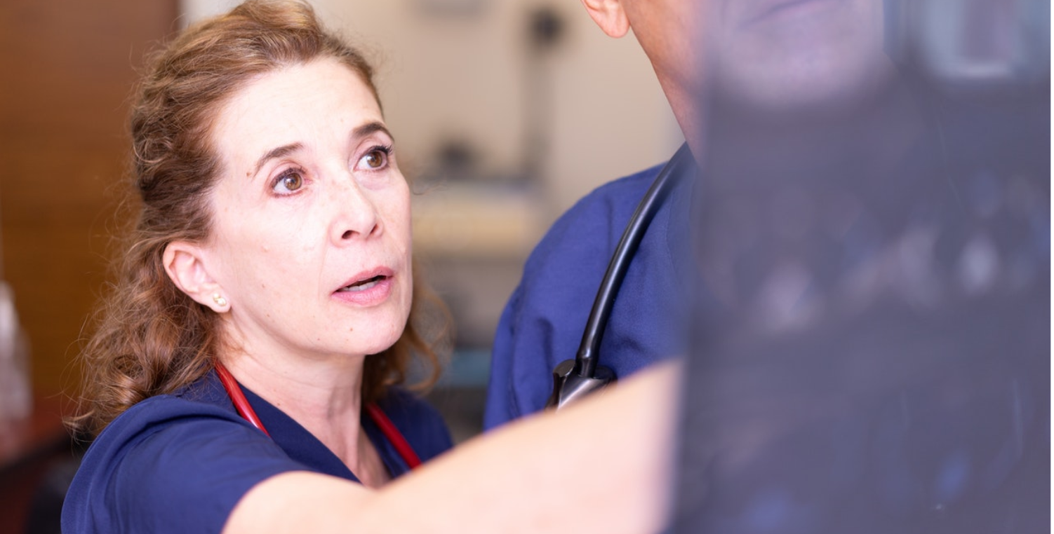 female doctor reviewing patient scans