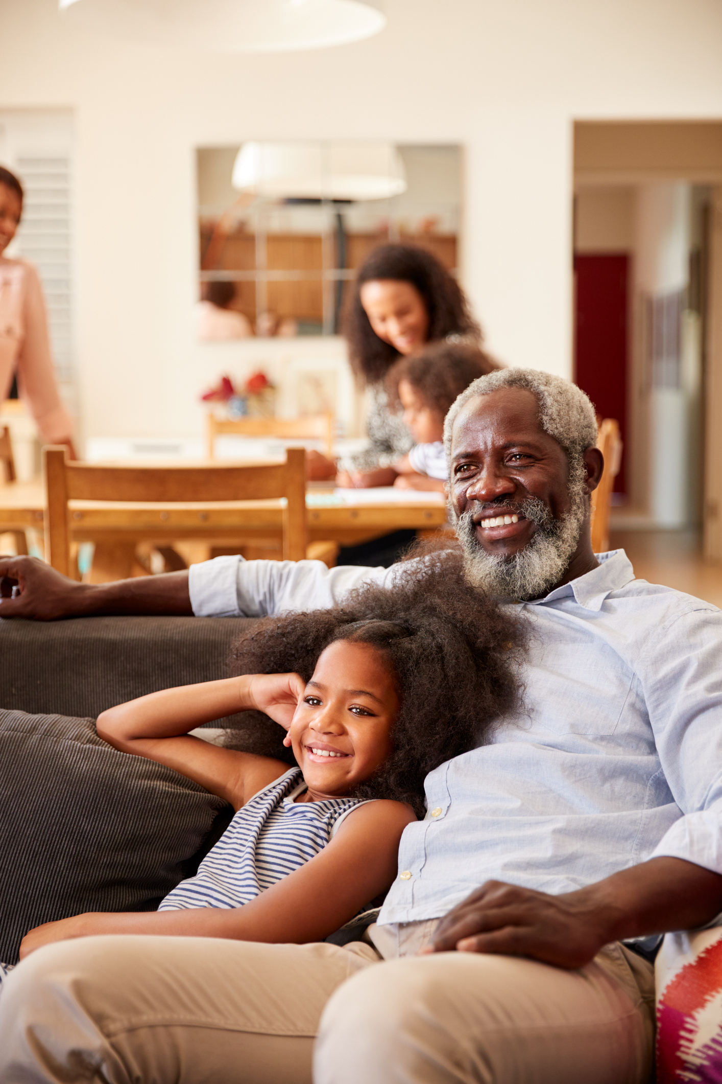 grandpa and child watching movie with family in background