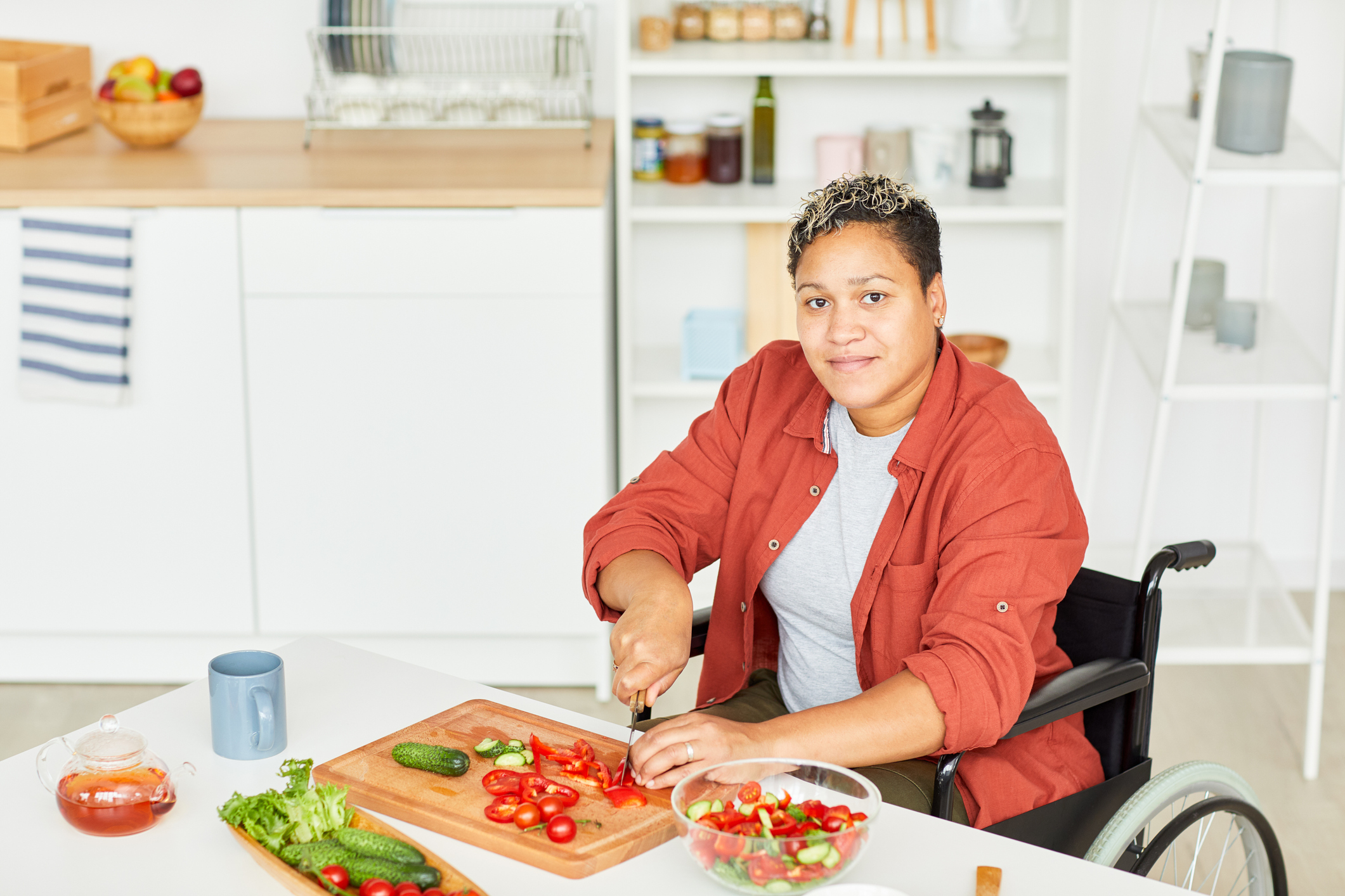 woman in wheelchair making a salad
