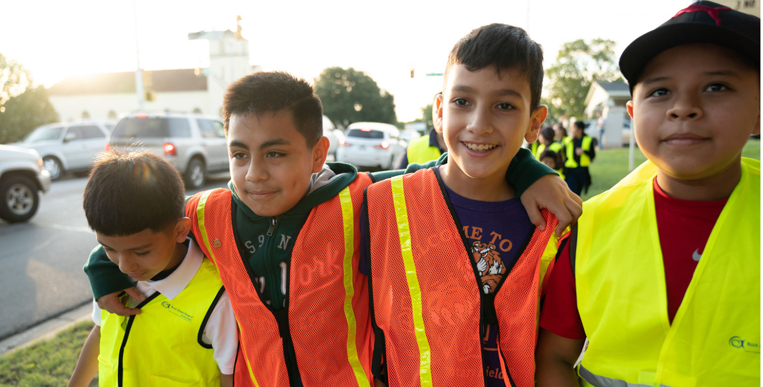 Four young students walking to school with BZP walking school bus