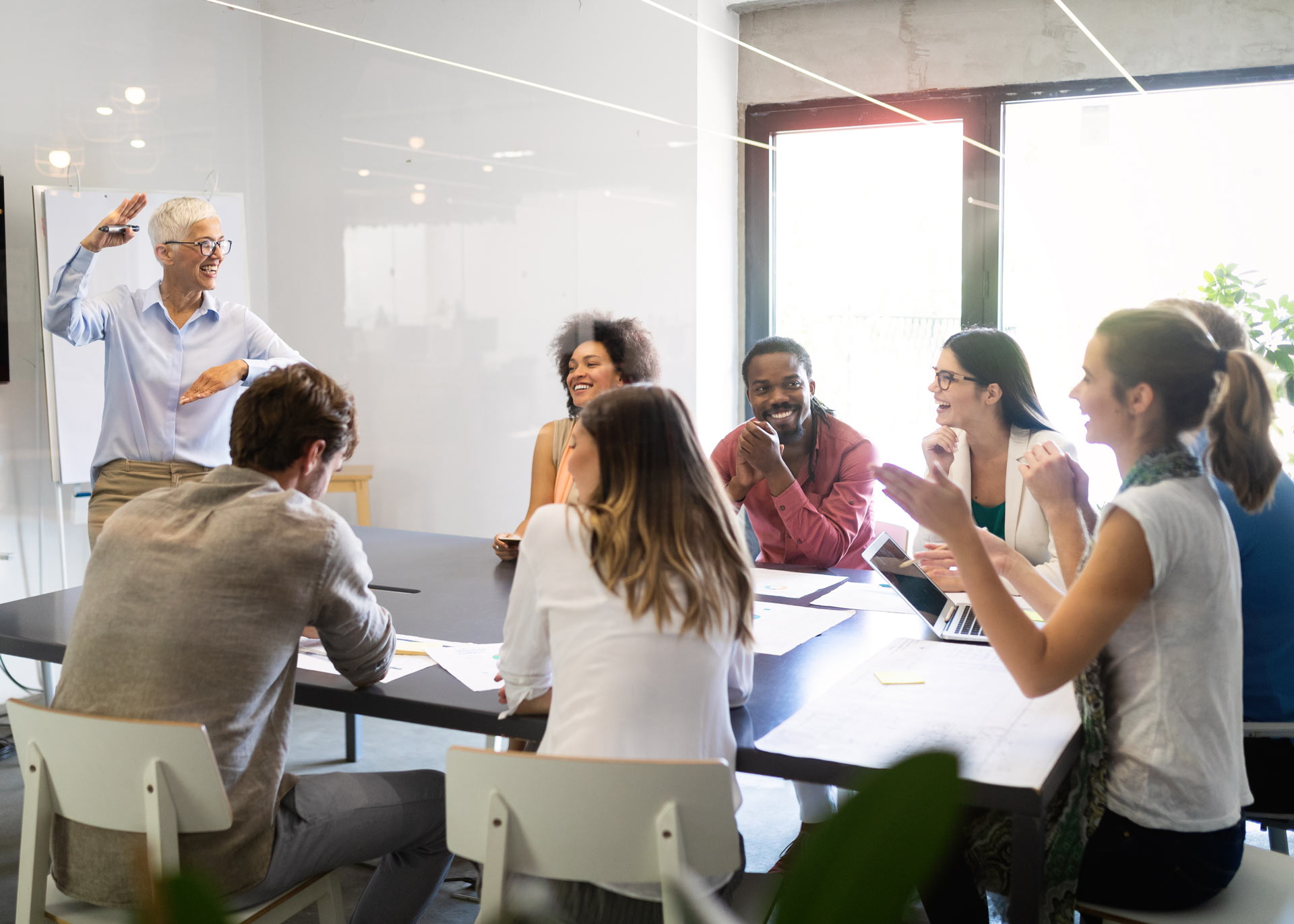 cheerful-coworkers-in-office-during-company-meeting