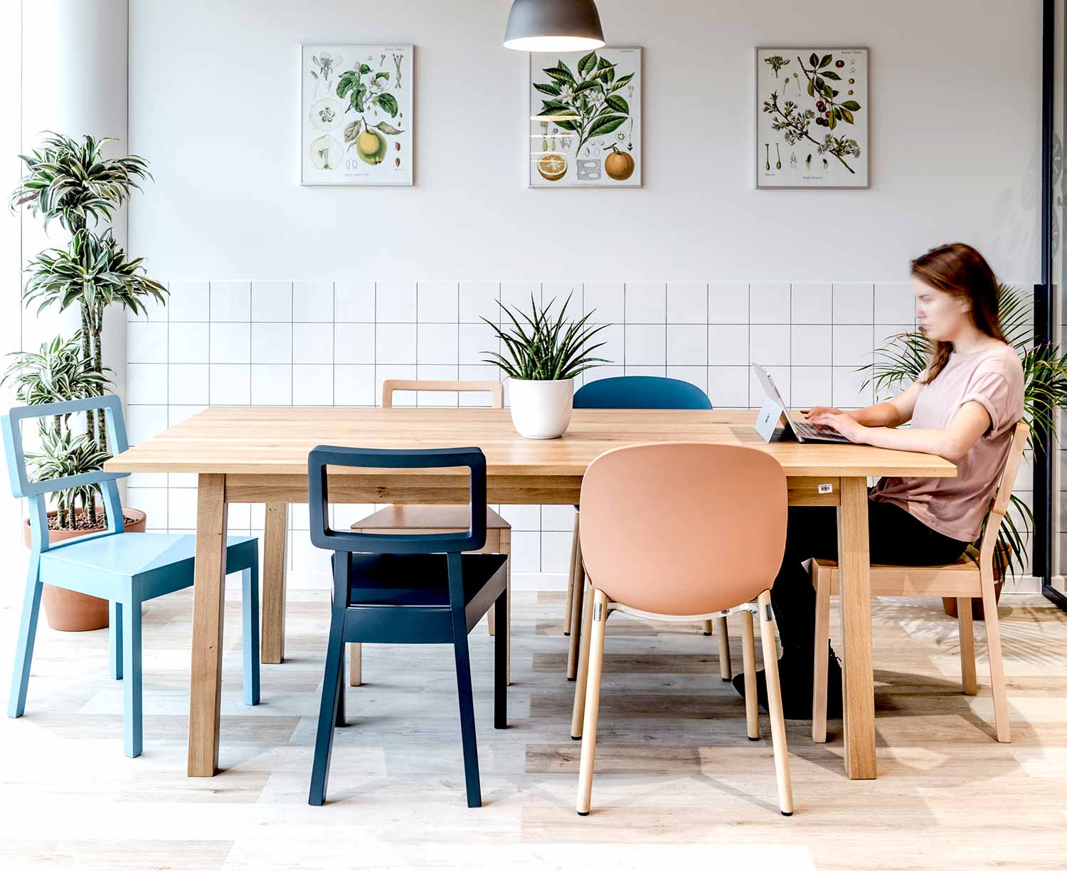 Bright scandinavian style cafeteria space in office featuring Coral RBM Noor chair with wooden legs