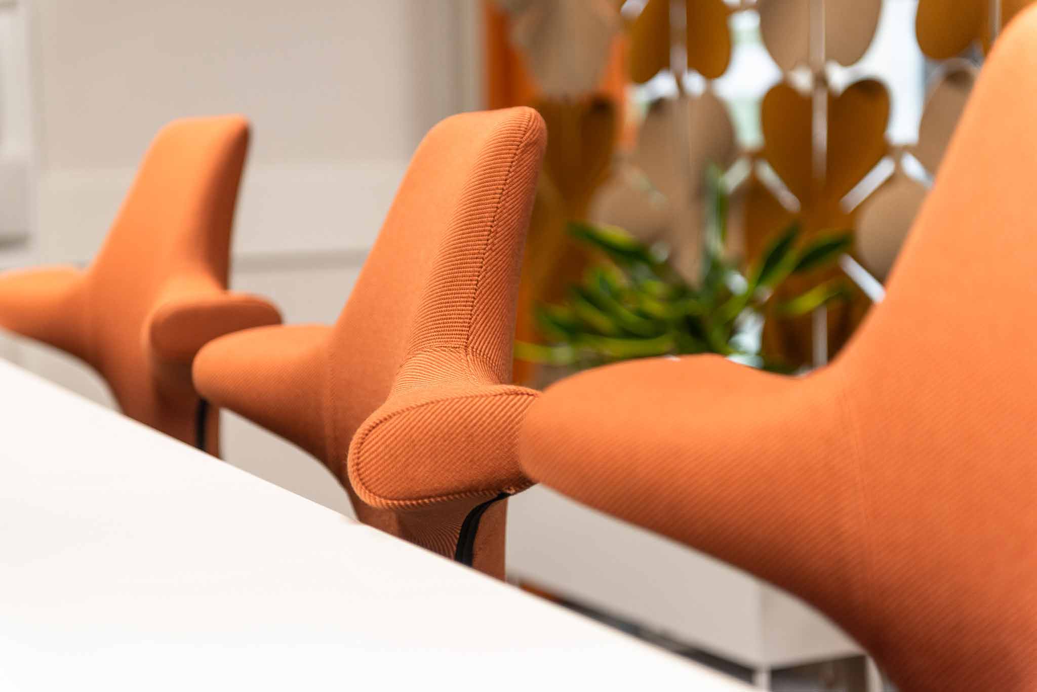 Clase up of Hag capisco chairs with orange fabric in skandia office in sundsvall