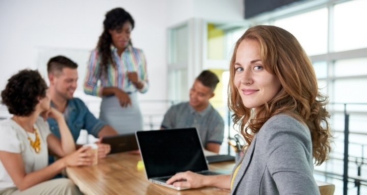 Woman and colleagues sitting at table with laptops and coffee-392943-edited.jpeg