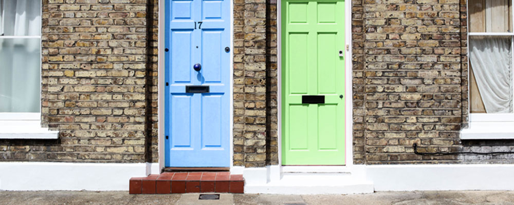 resources-library-featured-image-a-light-blue-and-light-green-set-of-doors-against-a-brick-wall