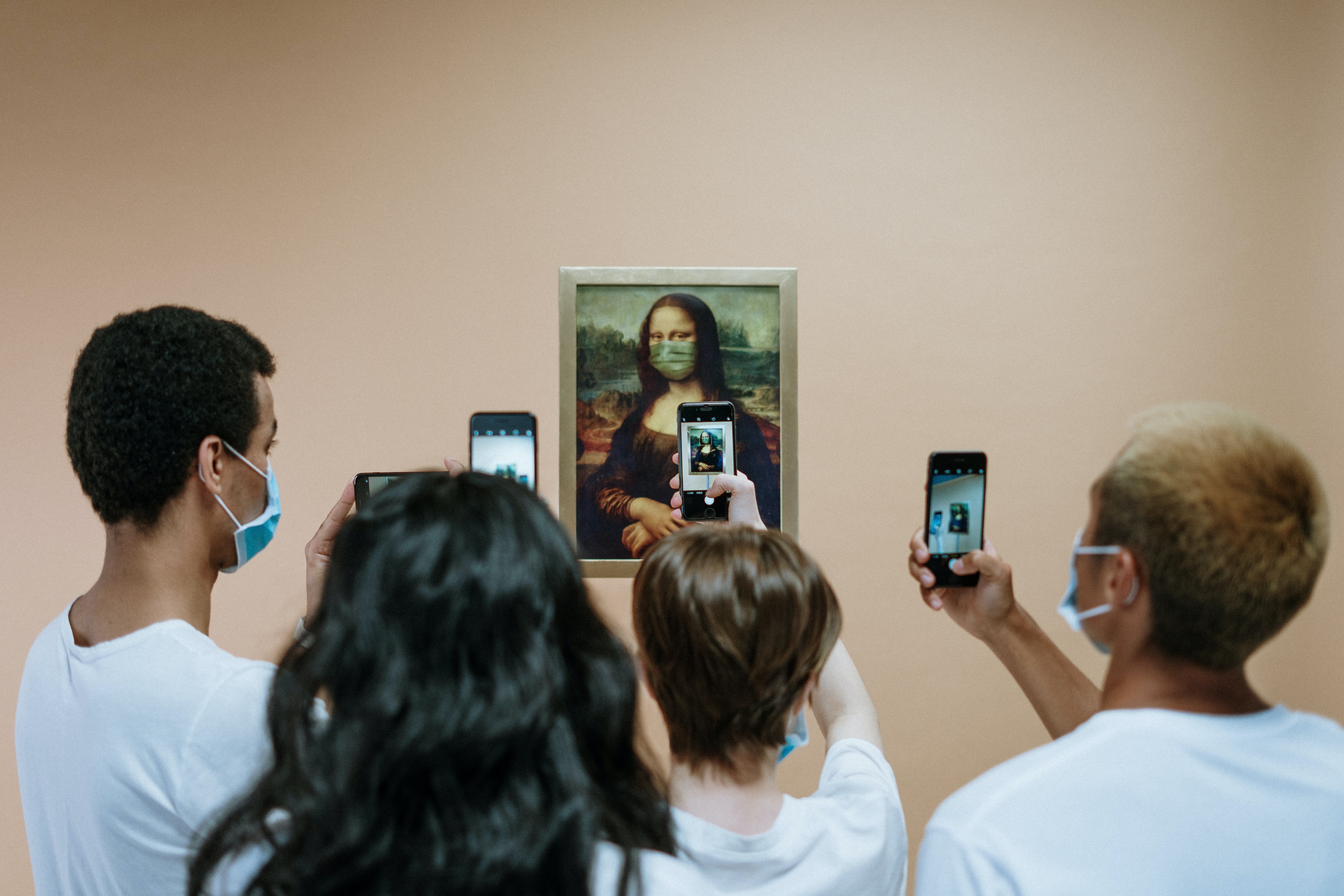 Crowd taking photos to the Mona Lisa in a COVID19 environment