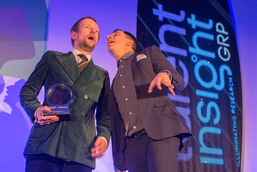 Talent MD David Steel collecting award from comedian Russell Kane