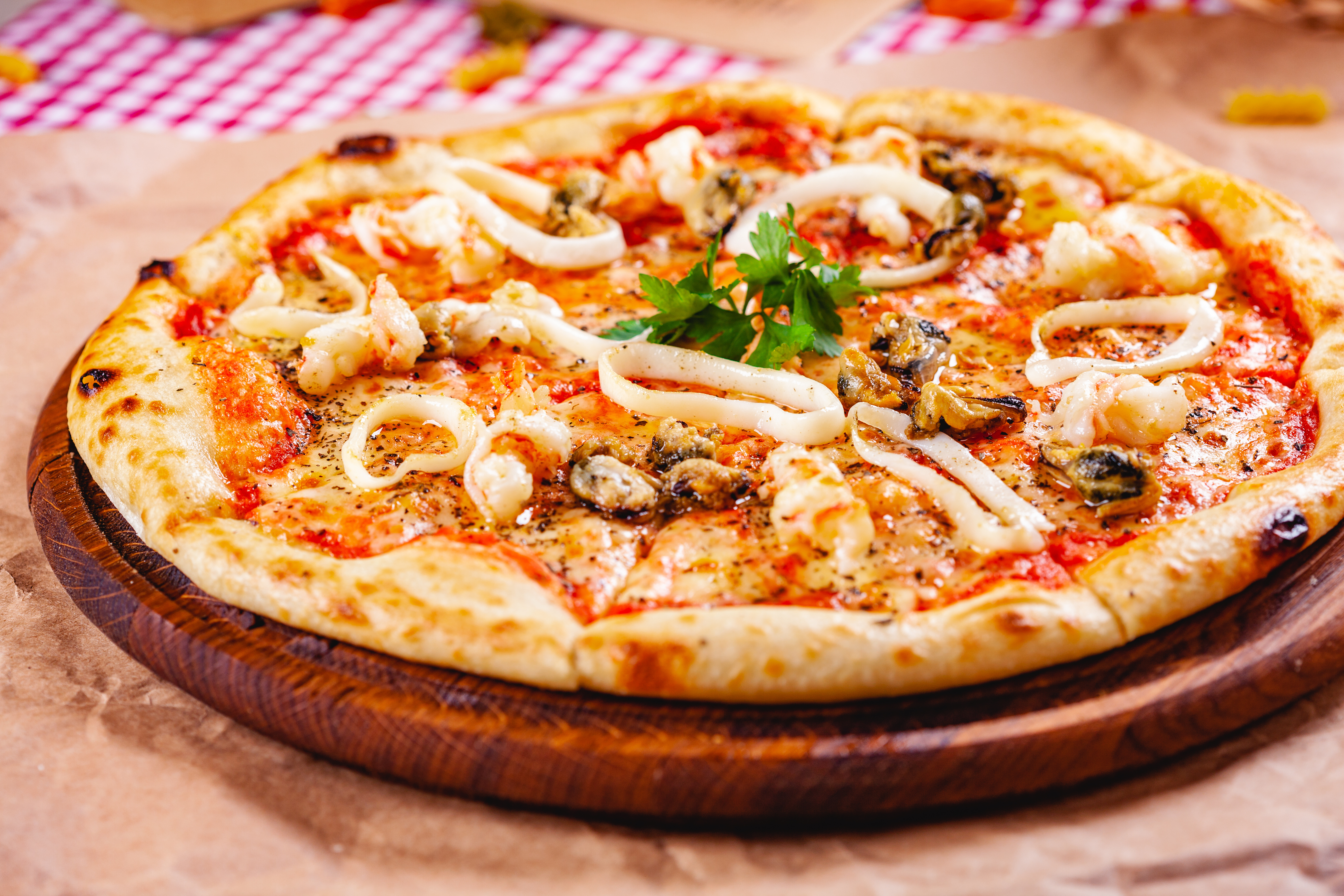 A calamari pizza on wooden board