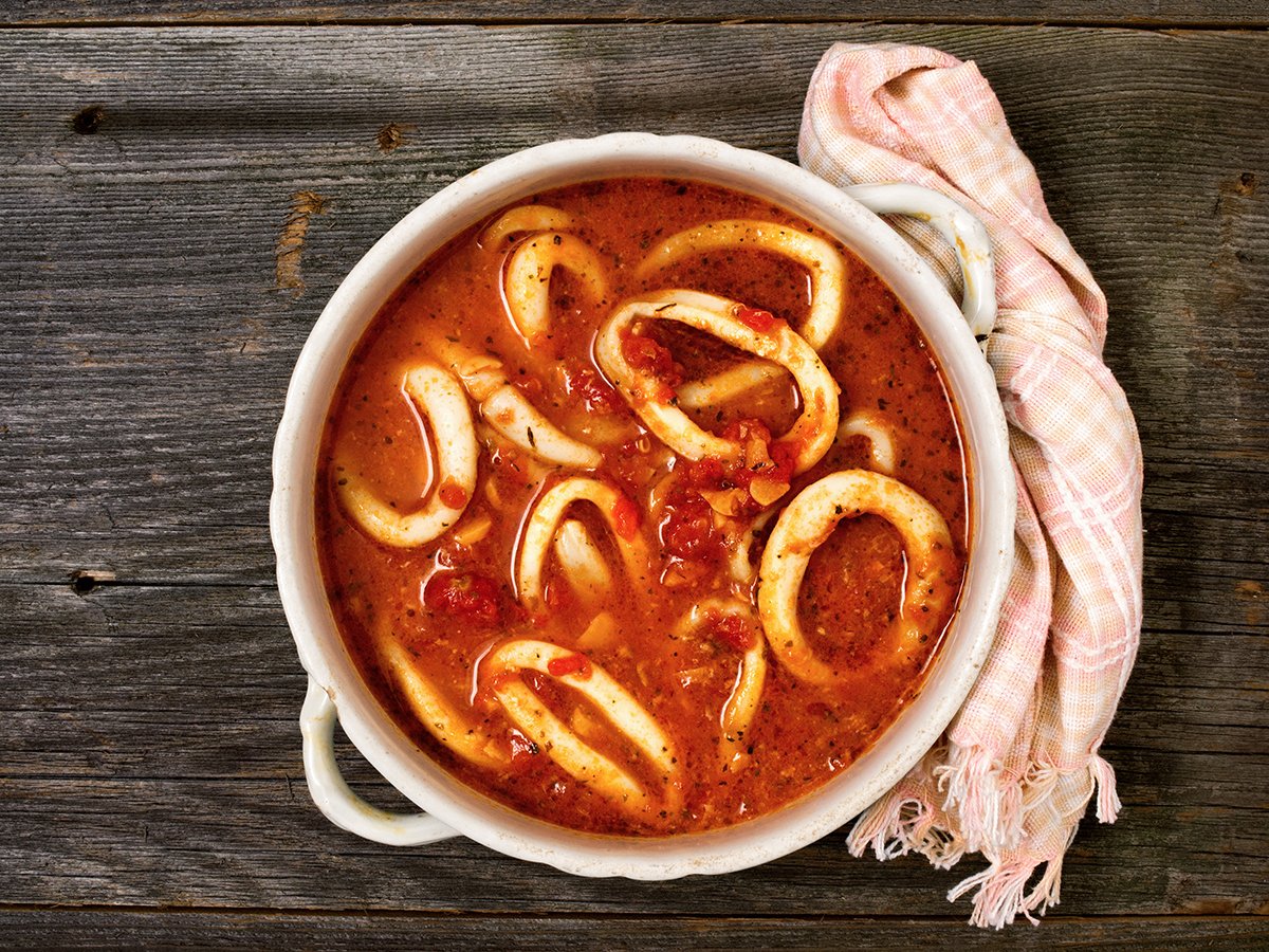 A rustic bowl of calamari rings in red sauce