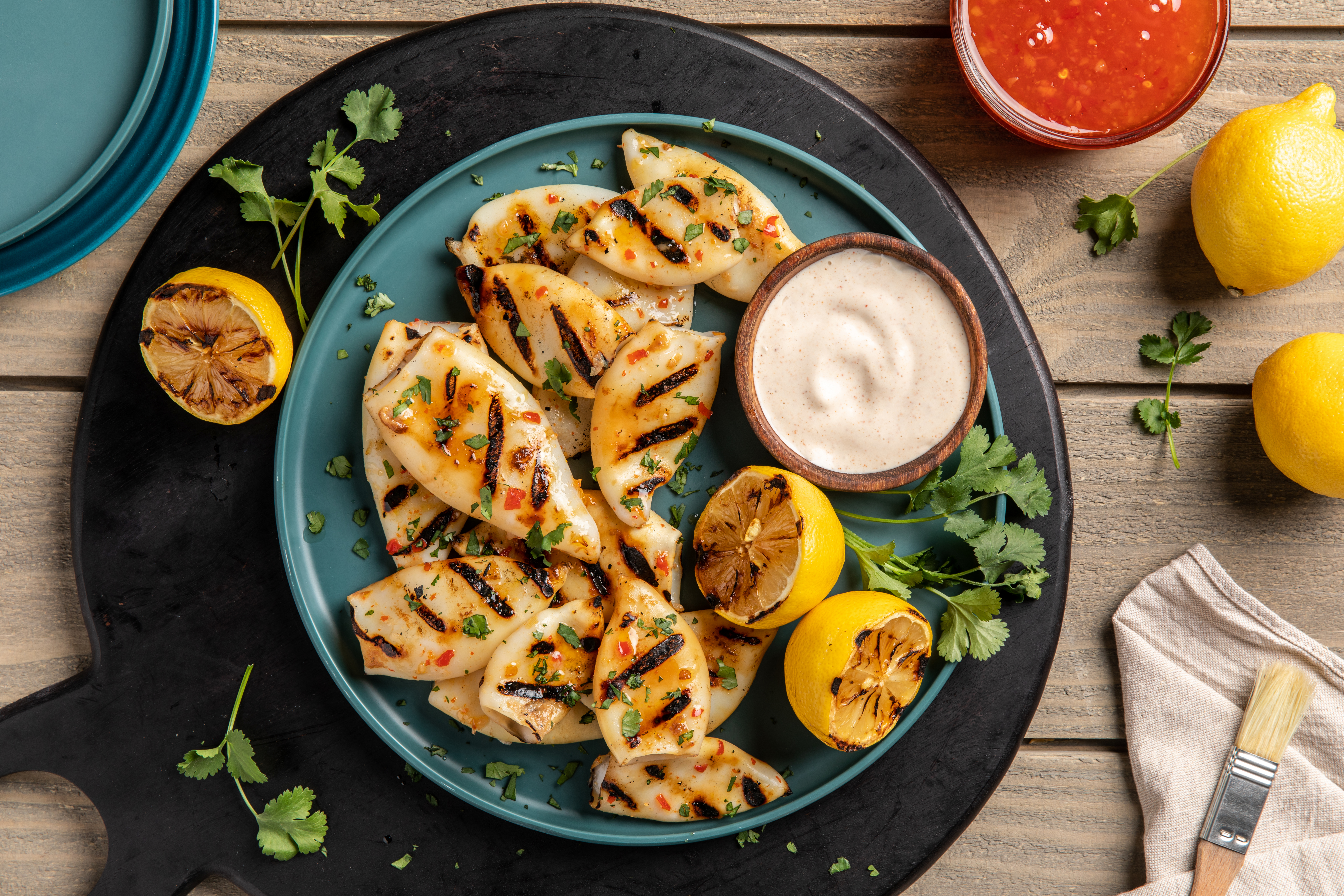 A round dish of BBQ grilled calamari tubes