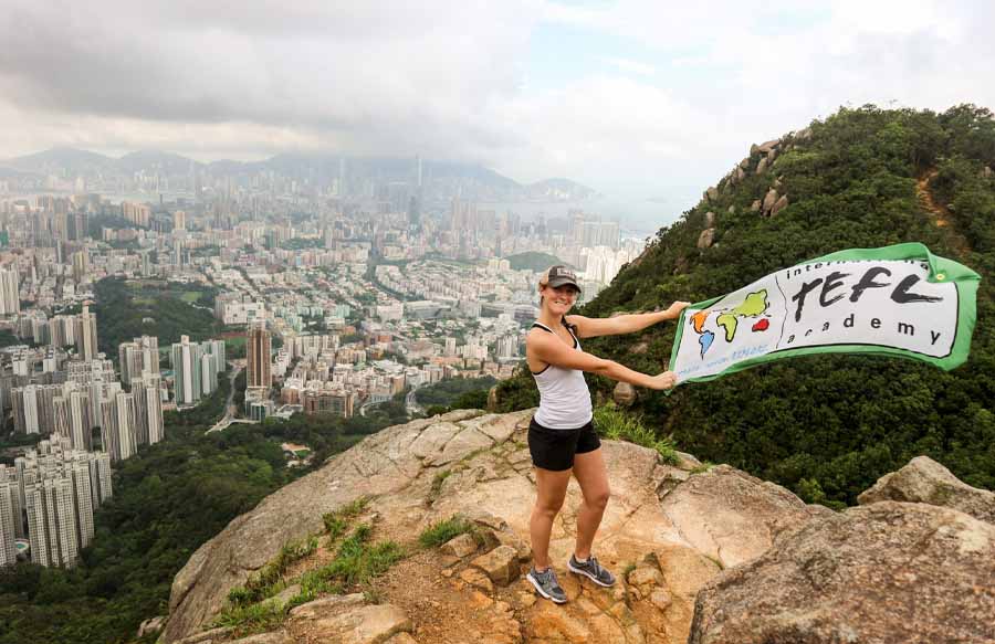 a female English teacher in Hong Kong with an ITA flag