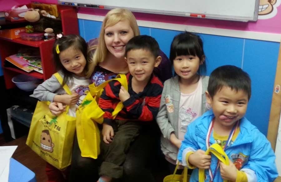 a female ESL teacher in Hong Kong with her TEFL students
