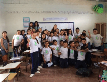 a female English teacher in Honduras with her students