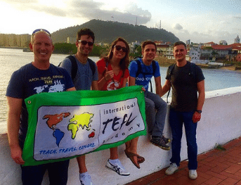 a group of English teachers in Panama with the International TEFL Academy flag