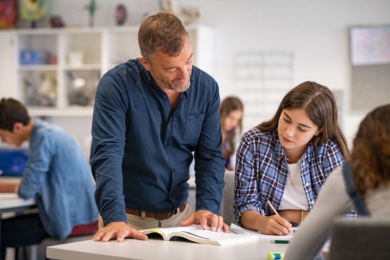 Language teacher helping student with an exam