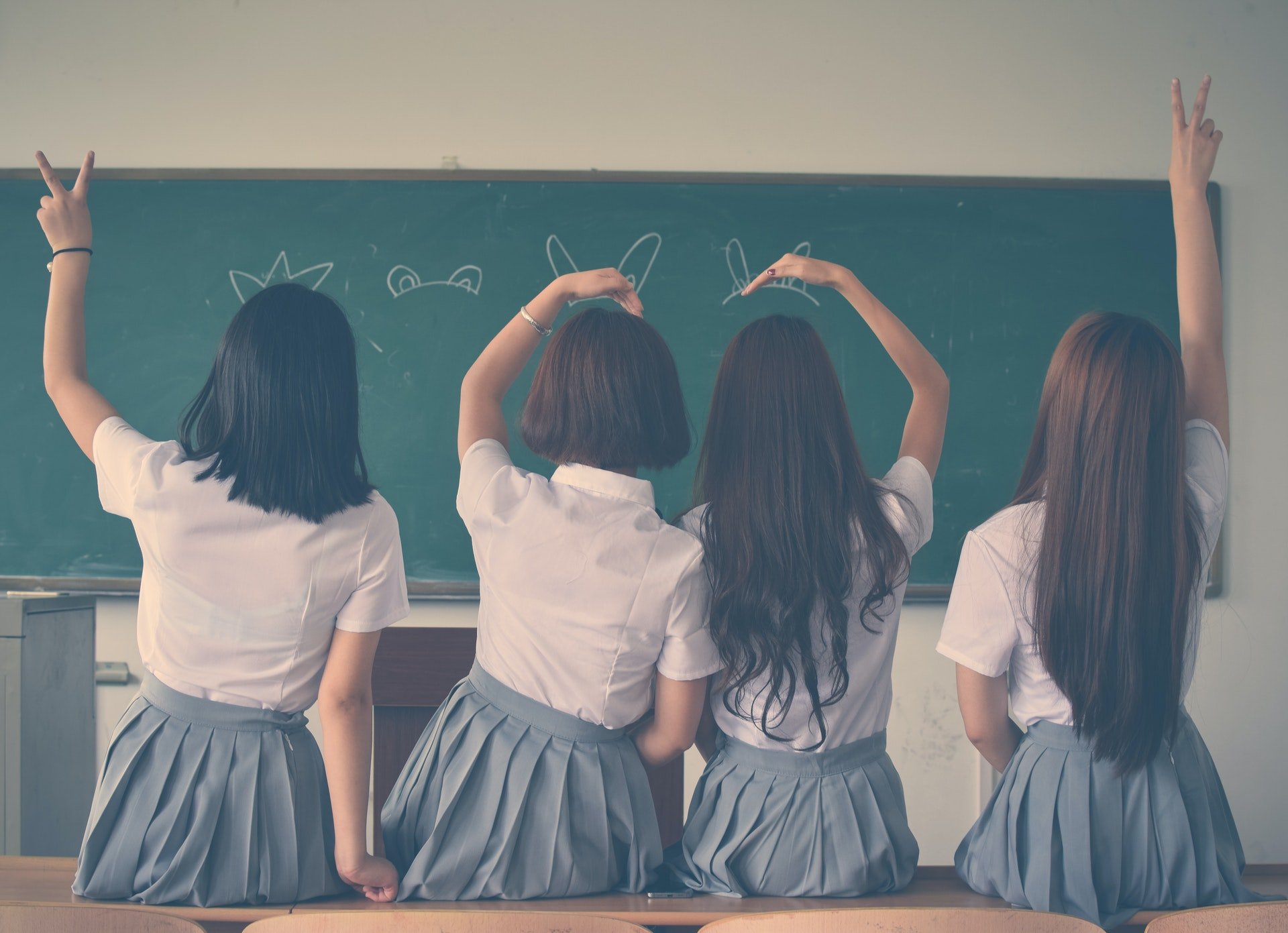 Photo of young female students inside of a school classroom
