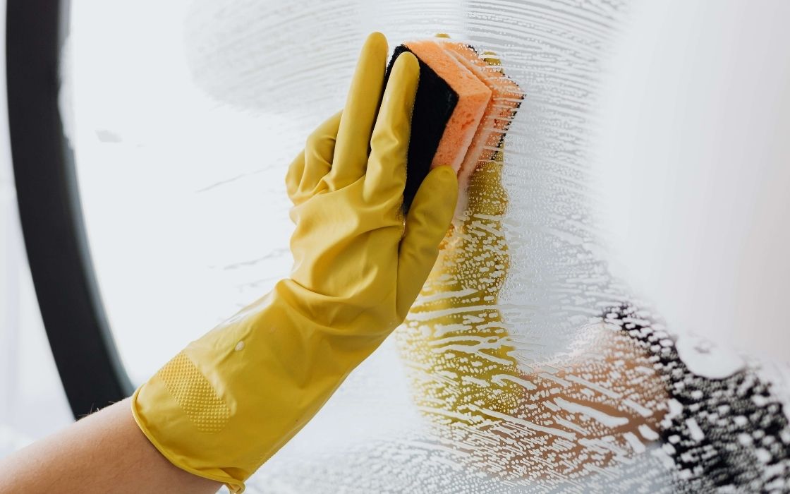 wiping mirror with rubber gloves