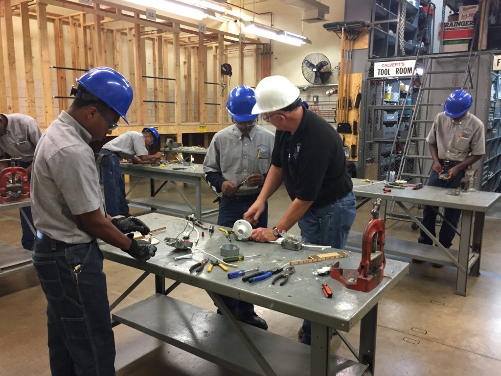 Leonard (left) working with a peer and his teacher, John Kurtz (right) at Western High School of Technology and Environmental Science.