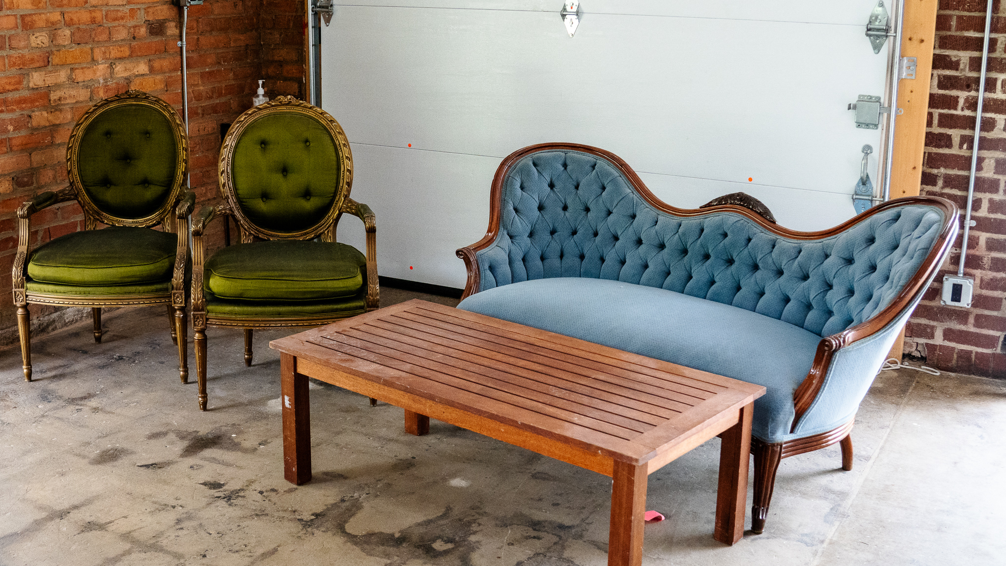 A vintage couch, coffee table and chairs. 